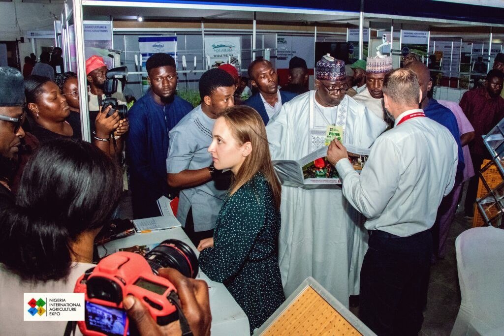 Visitors gathered around an agricultural exhibition stand