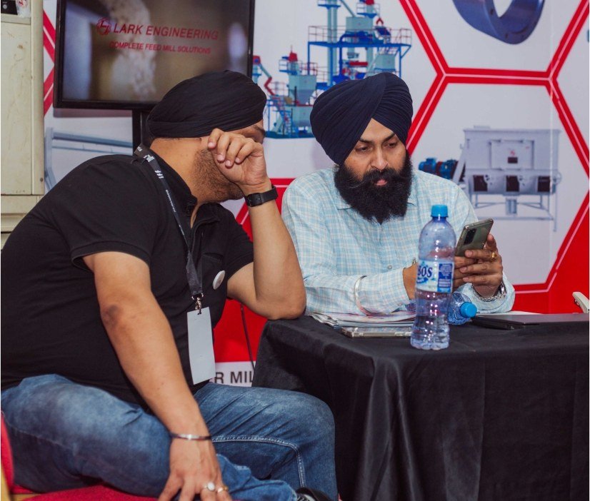 Participants discussing products at an exhibition stand