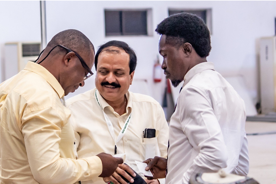 Business participants exchanging information during an exhibition conversation.
