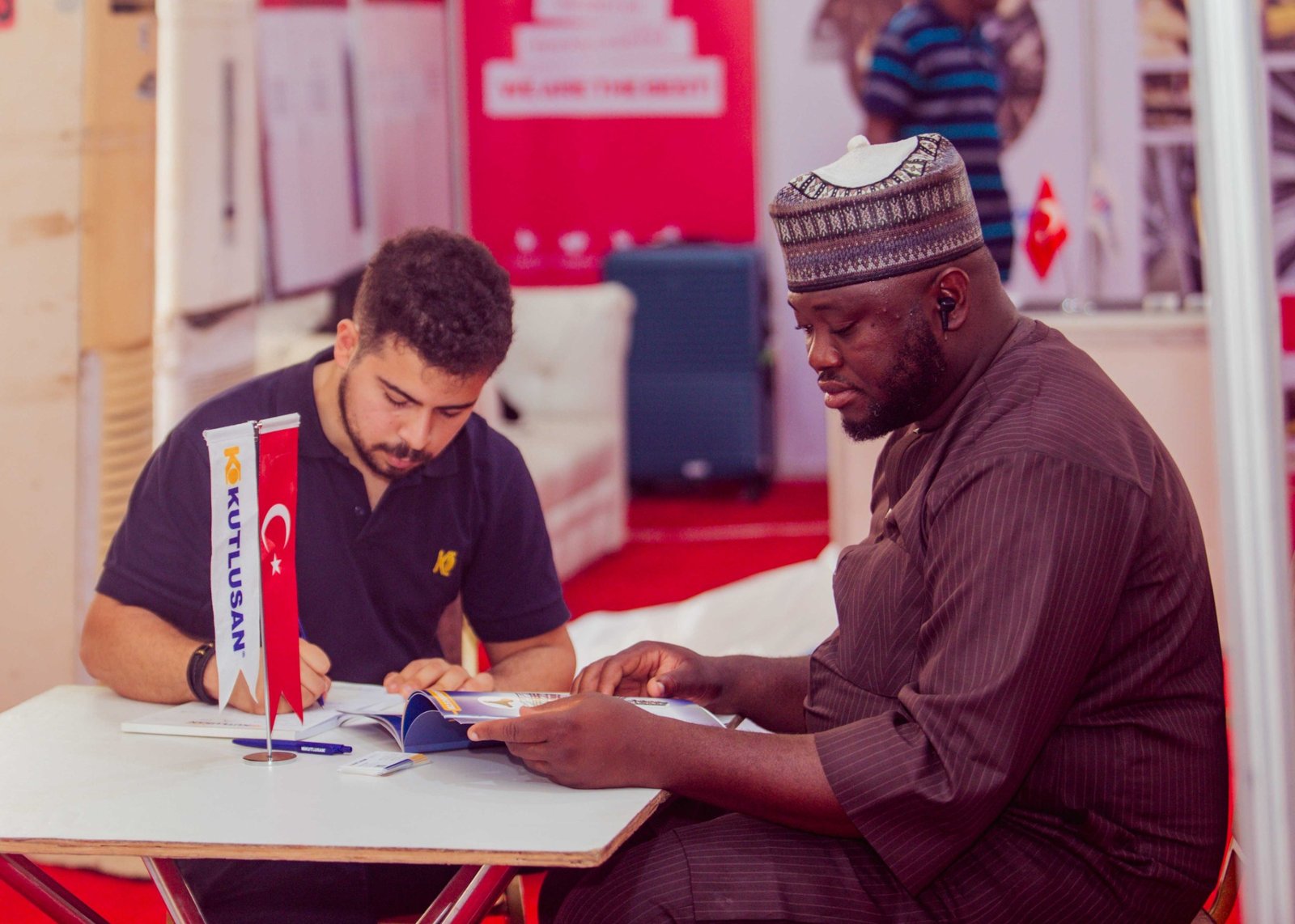 Participants reviewing product information during an exhibition meeting.