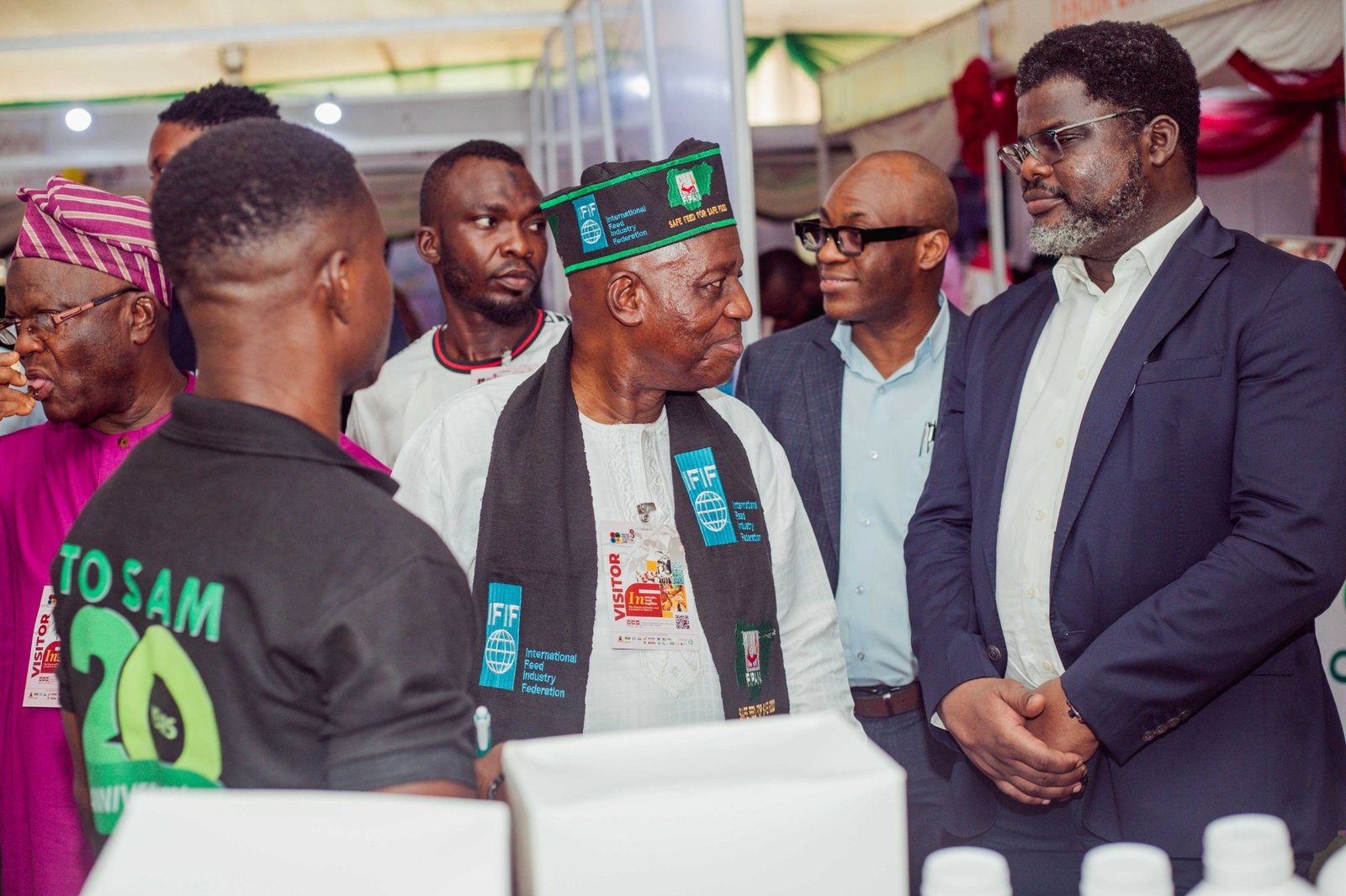 Industry participants in conversation on an exhibition stand.